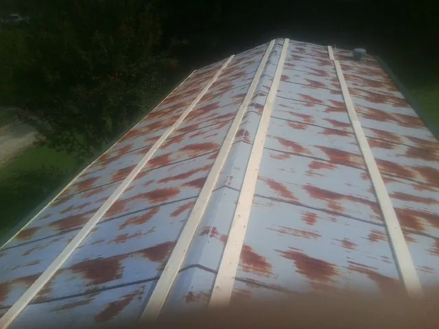 Rusted metal roof panels with new wood purlins before replacement — Storm Damage Roof Repair in Medicine Lodge by Roofing Brothers